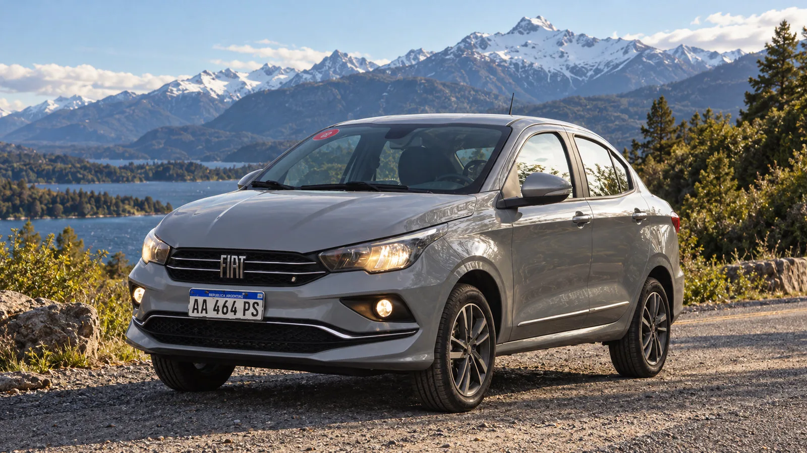 Fiat Cronos gris estacionado frente a un lago y la cordillera nevada